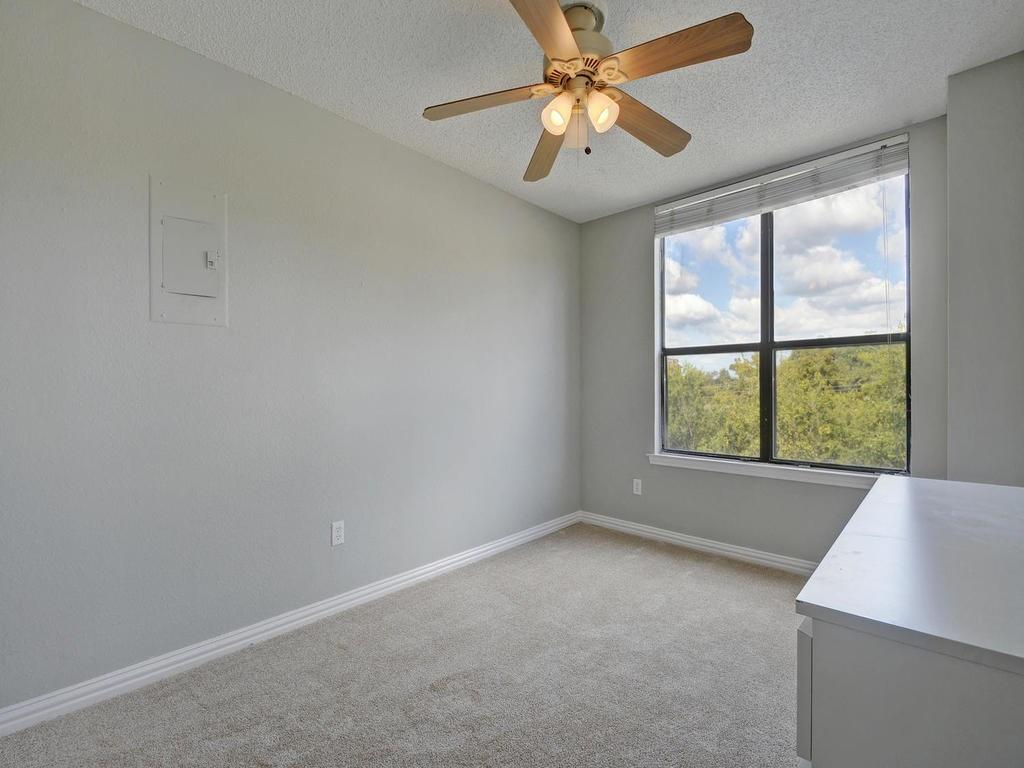 2409 Leon Street, Unit 207 Austin, TX 78705 - Photo 11 of 18 an empty room with a window and a fan