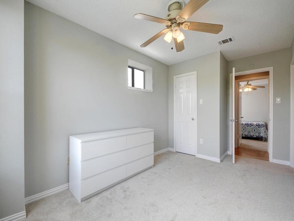 2409 Leon Street, Unit 207 Austin, TX 78705 - Photo 12 of 18 a view of room with chandelier fan and windows