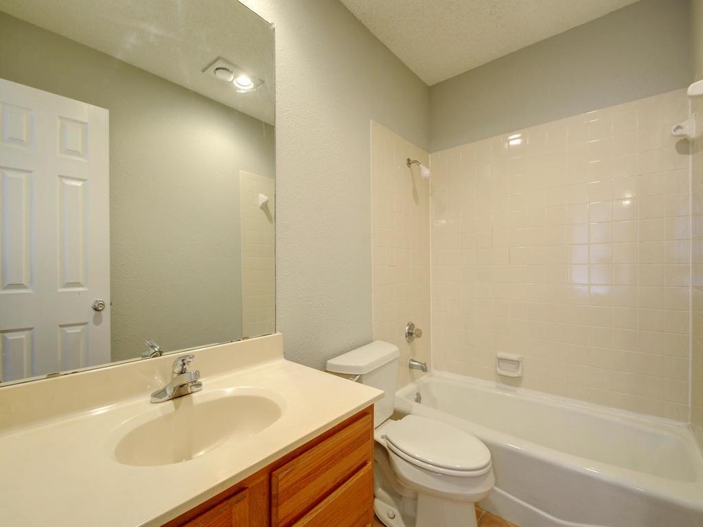 2409 Leon Street, Unit 207 Austin, TX 78705 - Photo 14 of 18 a bathroom with a sink a toilet and shower