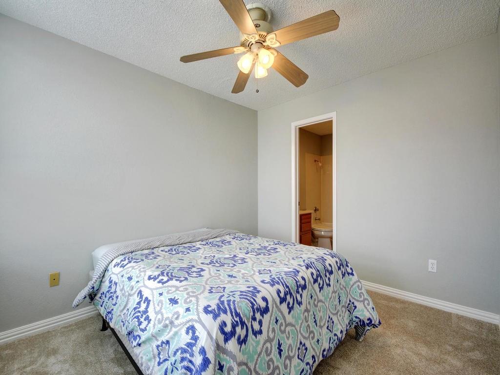 2409 Leon Street, Unit 207 Austin, TX 78705 - Photo 17 of 18 a bedroom with a bed and a chandelier
