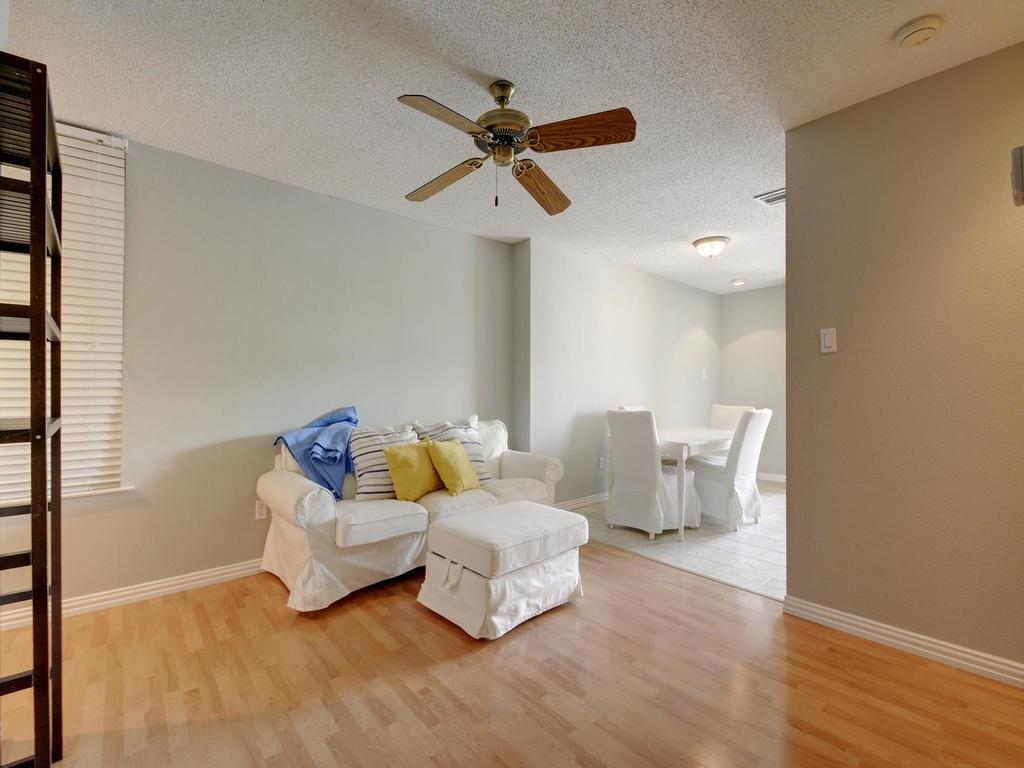 2409 Leon Street, Unit 207 Austin, TX 78705 - Photo 2 of 18 a living room with furniture and a ceiling fan