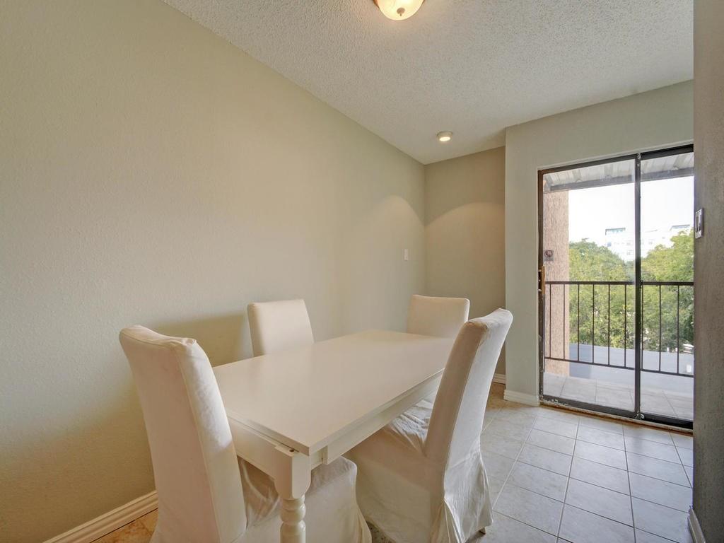 2409 Leon Street, Unit 207 Austin, TX 78705 - Photo 8 of 18 a view of a dining room with furniture and a potted plant
