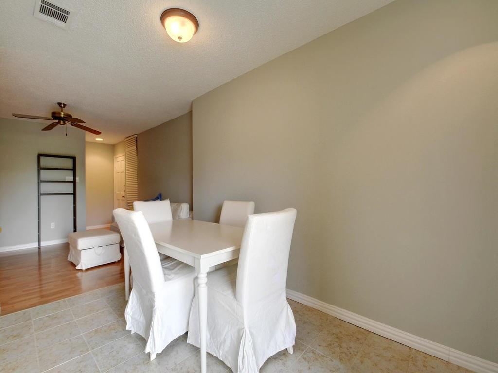 2409 Leon Street, Unit 207 Austin, TX 78705 - Photo 9 of 18 a view of a dining room with furniture and wooden floor