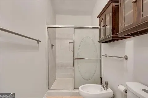 a bathroom with a toilet a sink and shower