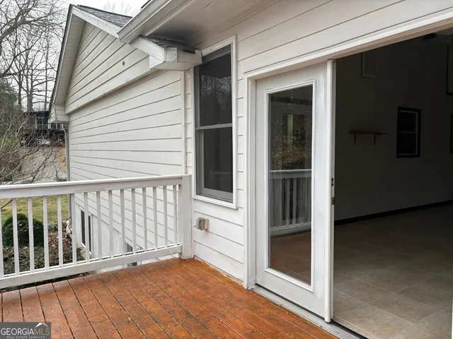 a view of a balcony with wooden floor and fence
