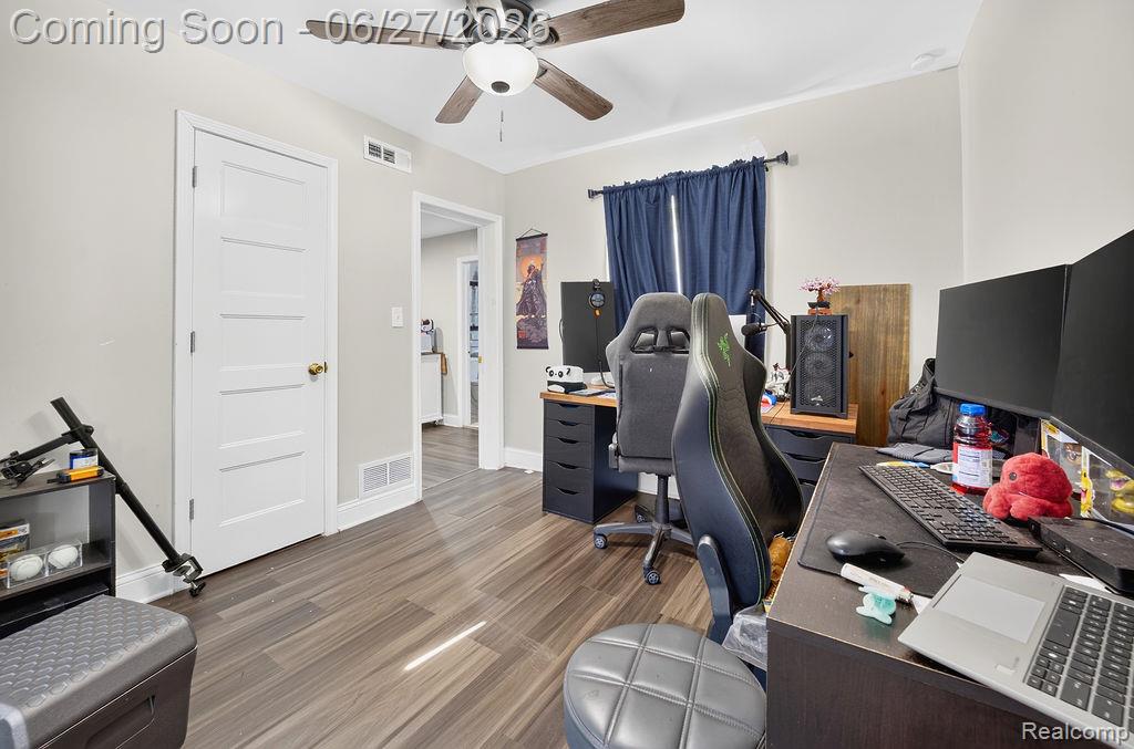 7715 Beech Daly Road Taylor, MI 48180 - Photo 15 of 21 Room featuring wood-finish flooring, a ceiling fan, white trim, and light-toned wall paint