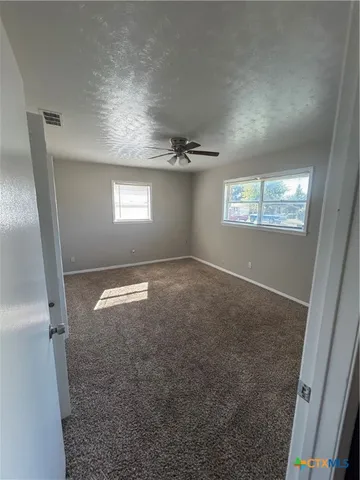 a view of empty room with windows