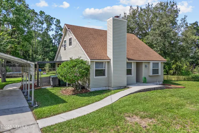 a front view of house with a garden and patio