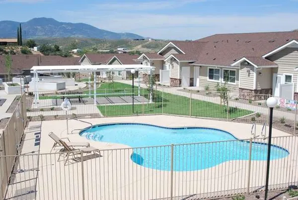 a view of a house with backyard porch and sitting area