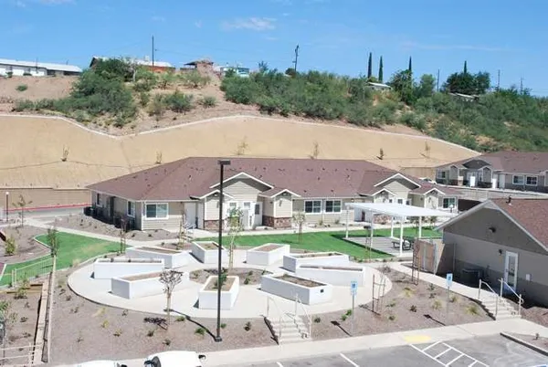 a aerial view of a house with a garden and lake view