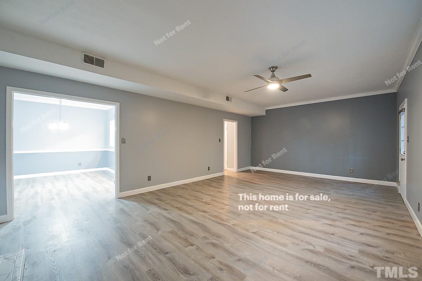 6335 New Market Way, Unit 1 Raleigh, NC 27615 - Photo 11 of 22 a view of an empty room with wooden floor and a ceiling fan