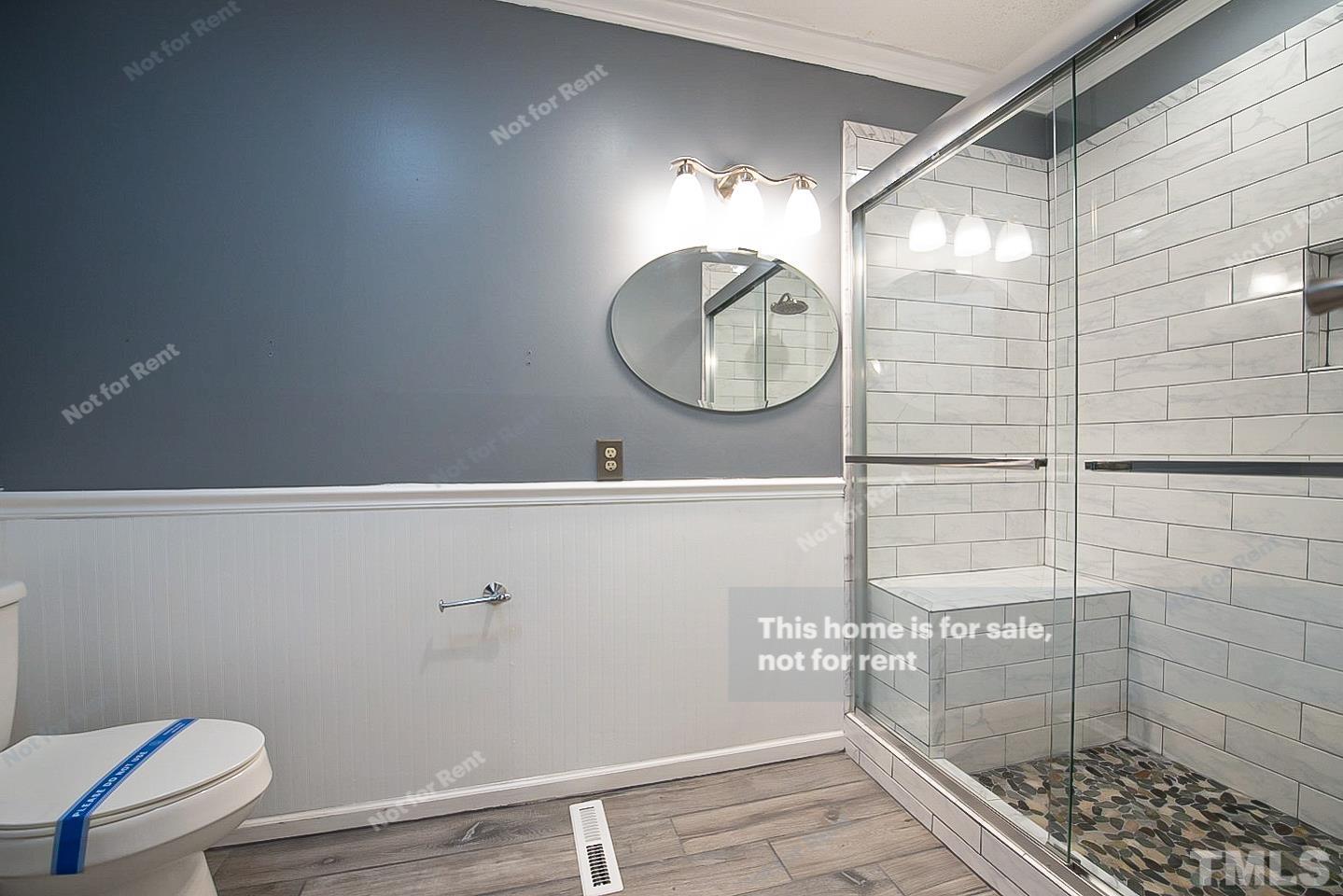 6335 New Market Way, Unit 1 Raleigh, NC 27615 - Photo 17 of 22 a bathroom with a sink and a mirror