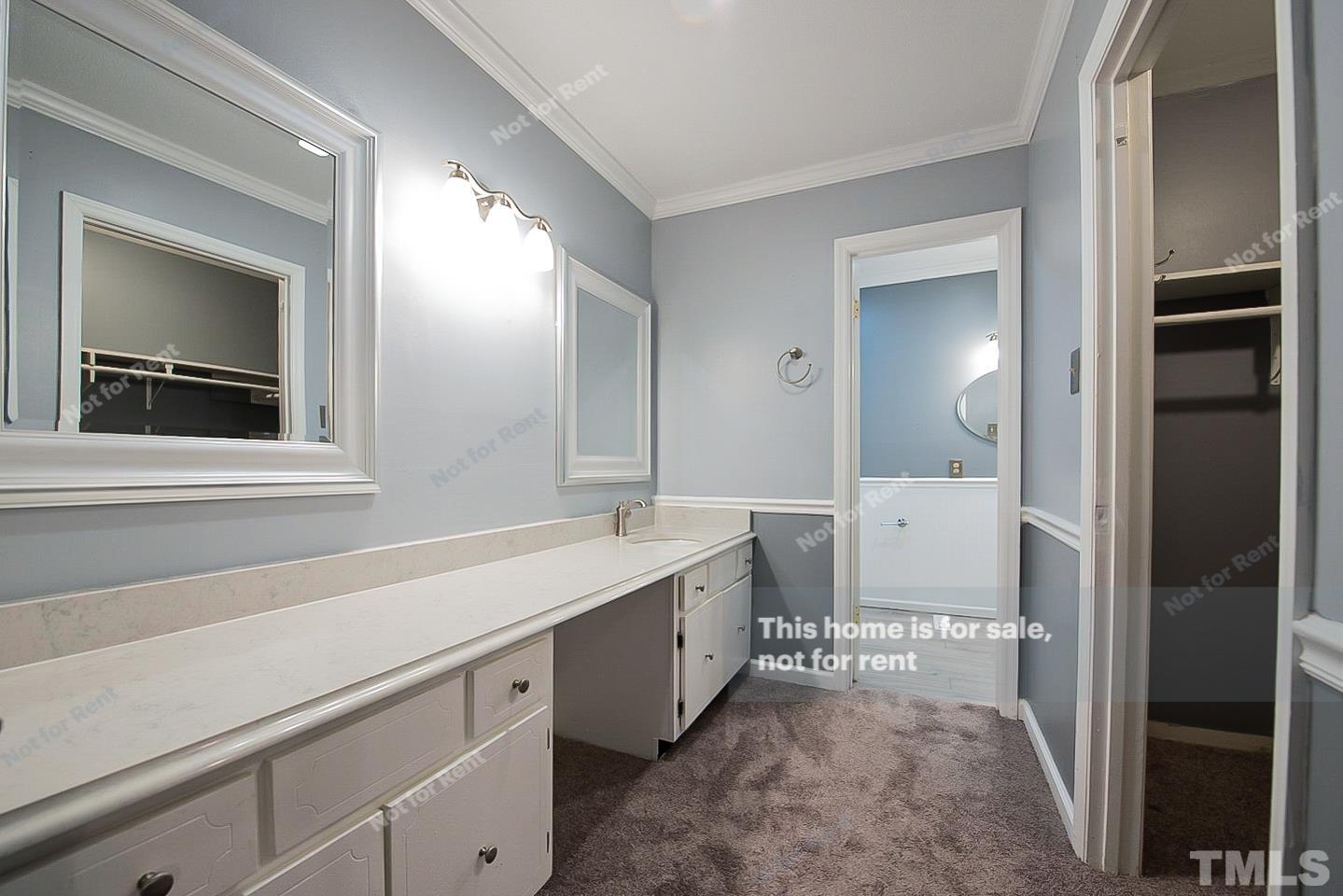 6335 New Market Way, Unit 1 Raleigh, NC 27615 - Photo 18 of 22 a spacious bathroom with a sink and a mirror