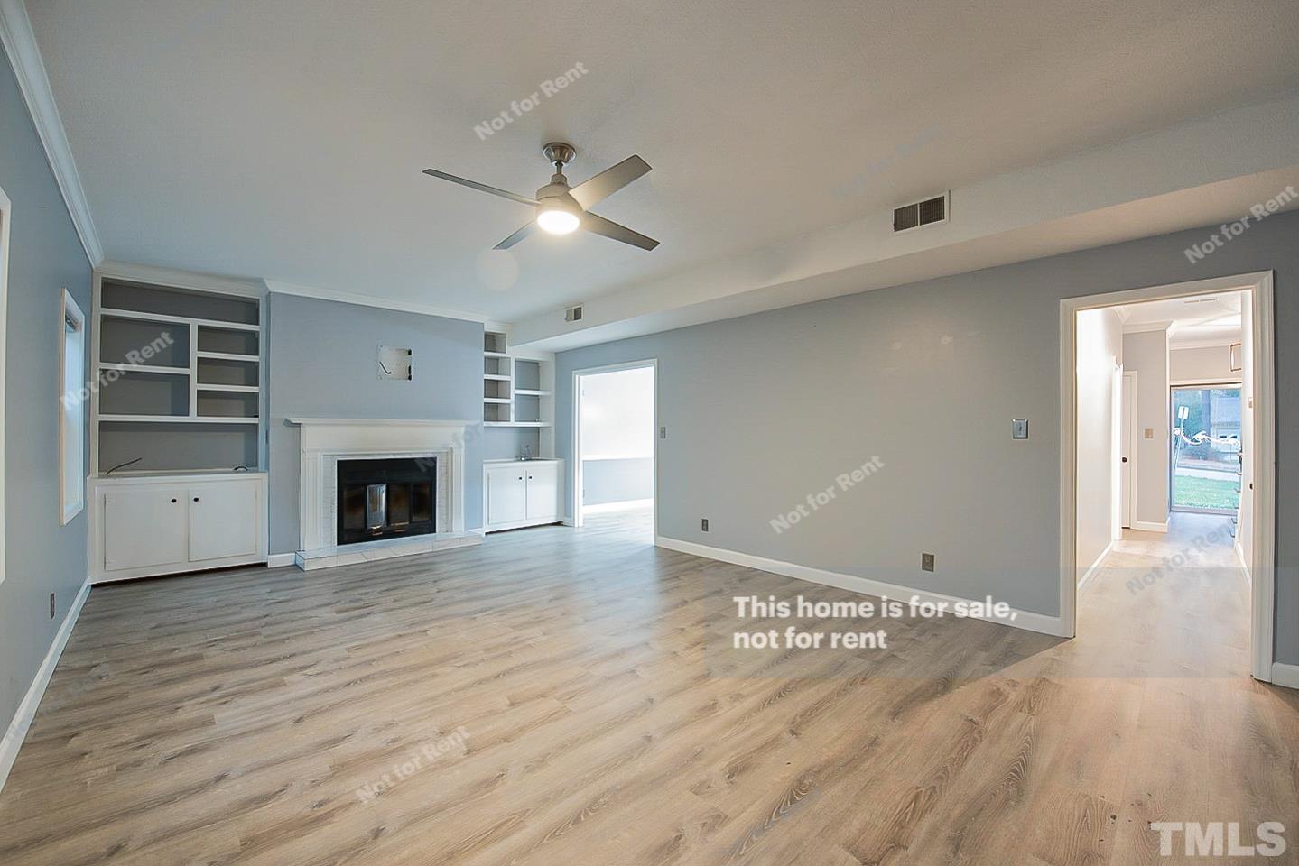 6335 New Market Way, Unit 1 Raleigh, NC 27615 - Photo 5 of 22 a view of empty room with wooden floor and fireplace