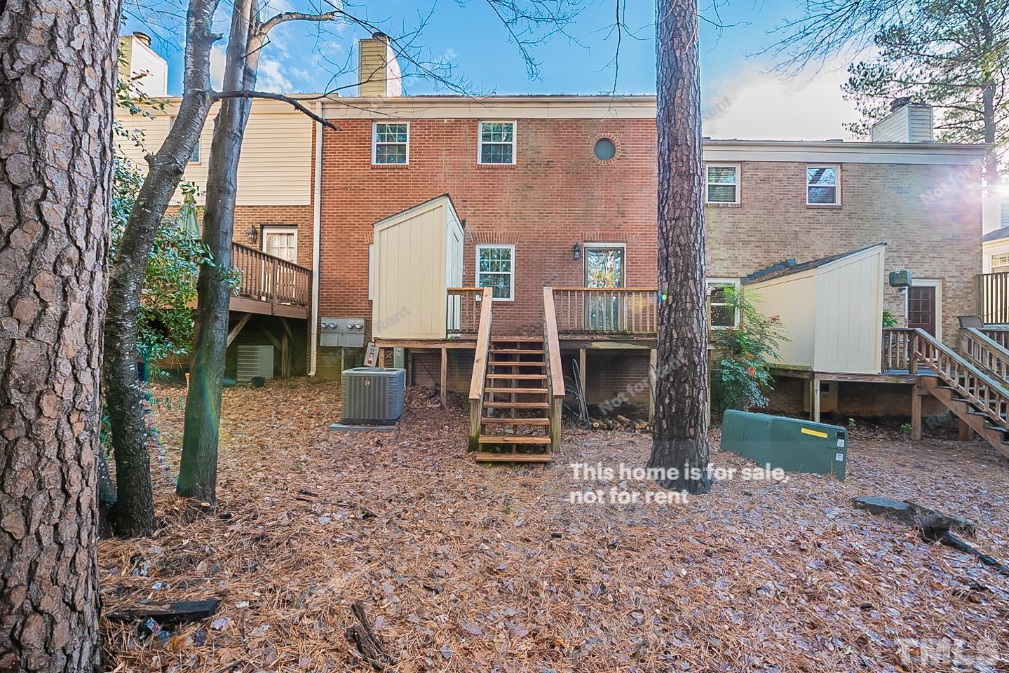 6335 New Market Way, Unit 1 Raleigh, NC 27615 - Photo 7 of 22 a view of a house with a yard and large tree
