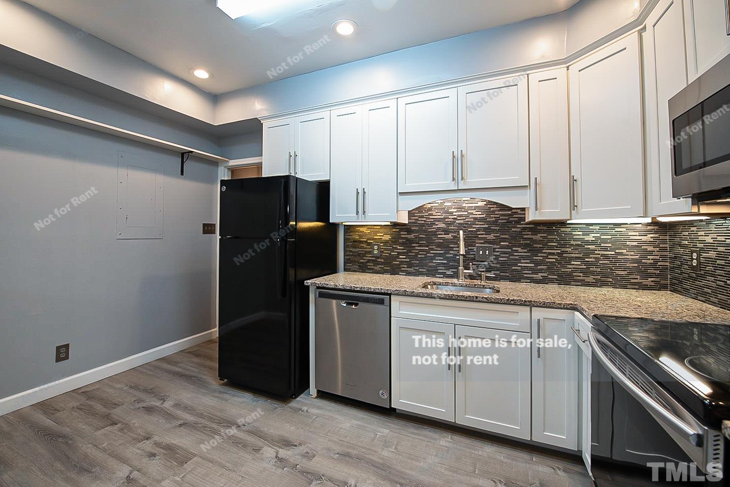 6335 New Market Way, Unit 1 Raleigh, NC 27615 - Photo 9 of 22 a kitchen with stainless steel appliances granite countertop a refrigerator and a sink