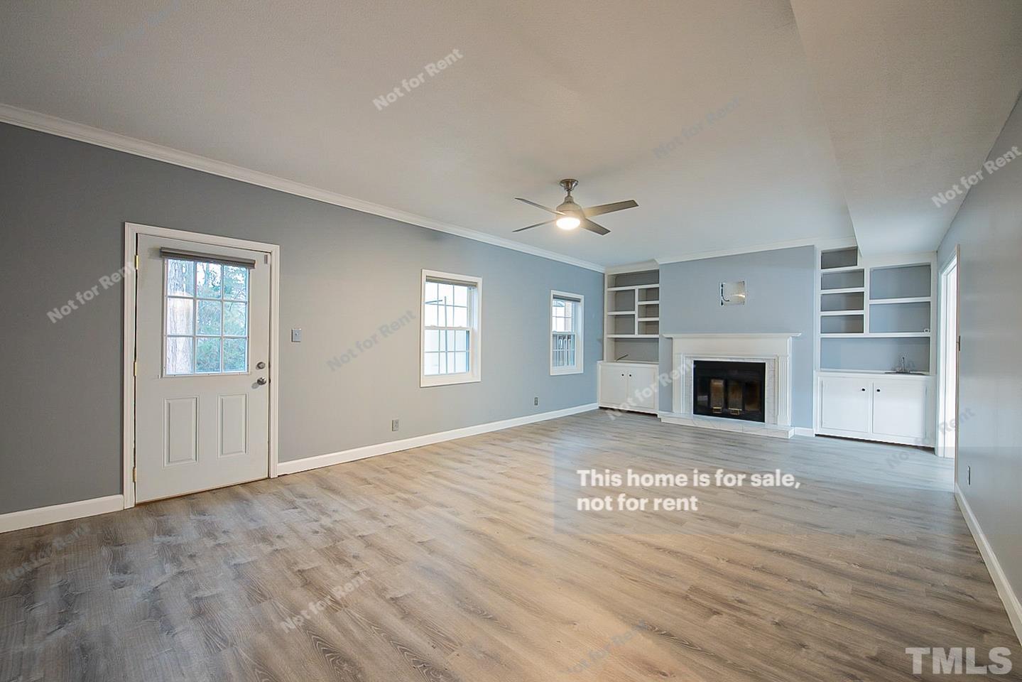 6335 New Market Way, Unit 1 Raleigh, NC 27615 - Photo 10 of 22 a view of an empty room with a fireplace and a window