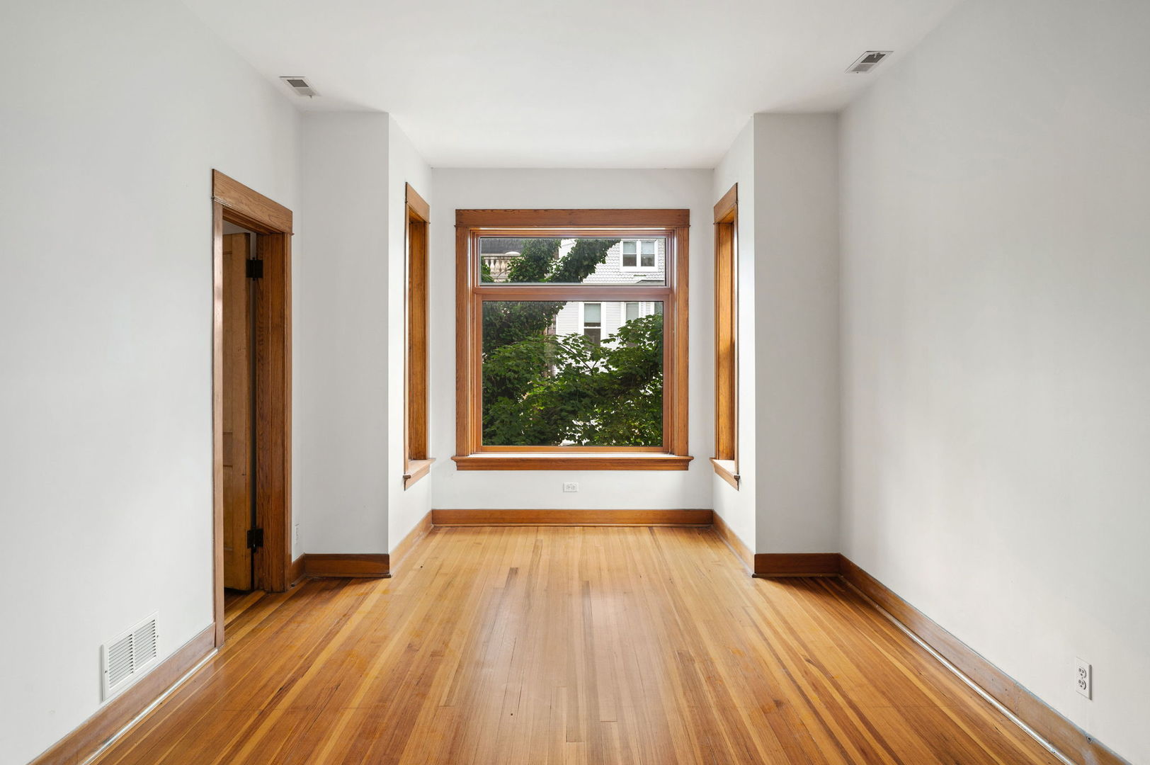 1415 West George Street Chicago, IL 60657 - Photo 13 of 35 an empty room with wooden floor and windows