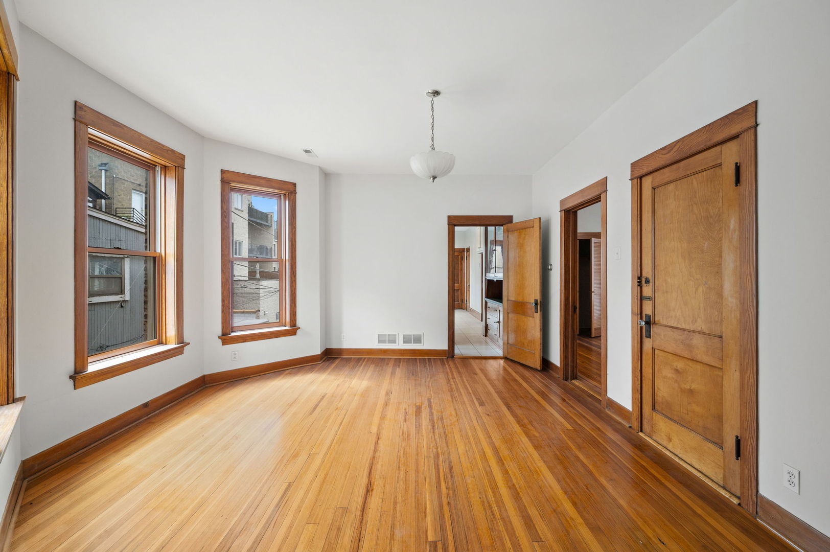 1415 West George Street Chicago, IL 60657 - Photo 16 of 35 a view of a room with wooden floor and windows