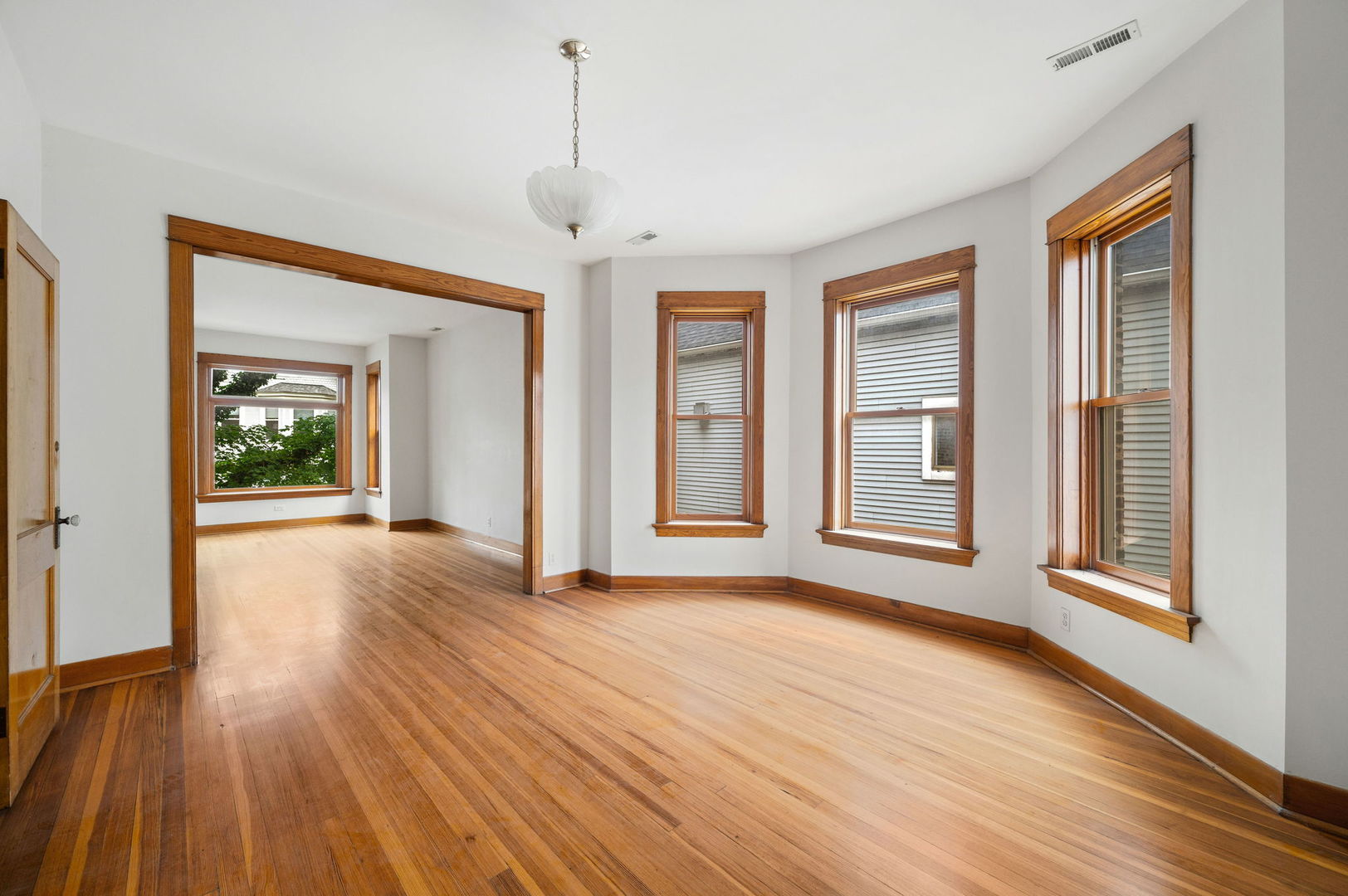 1415 West George Street Chicago, IL 60657 - Photo 17 of 35 a view of an empty room with wooden floor and a window