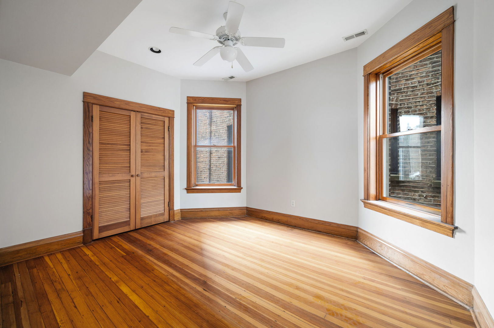 1415 West George Street Chicago, IL 60657 - Photo 20 of 35 a view of an empty room with wooden floor and a window