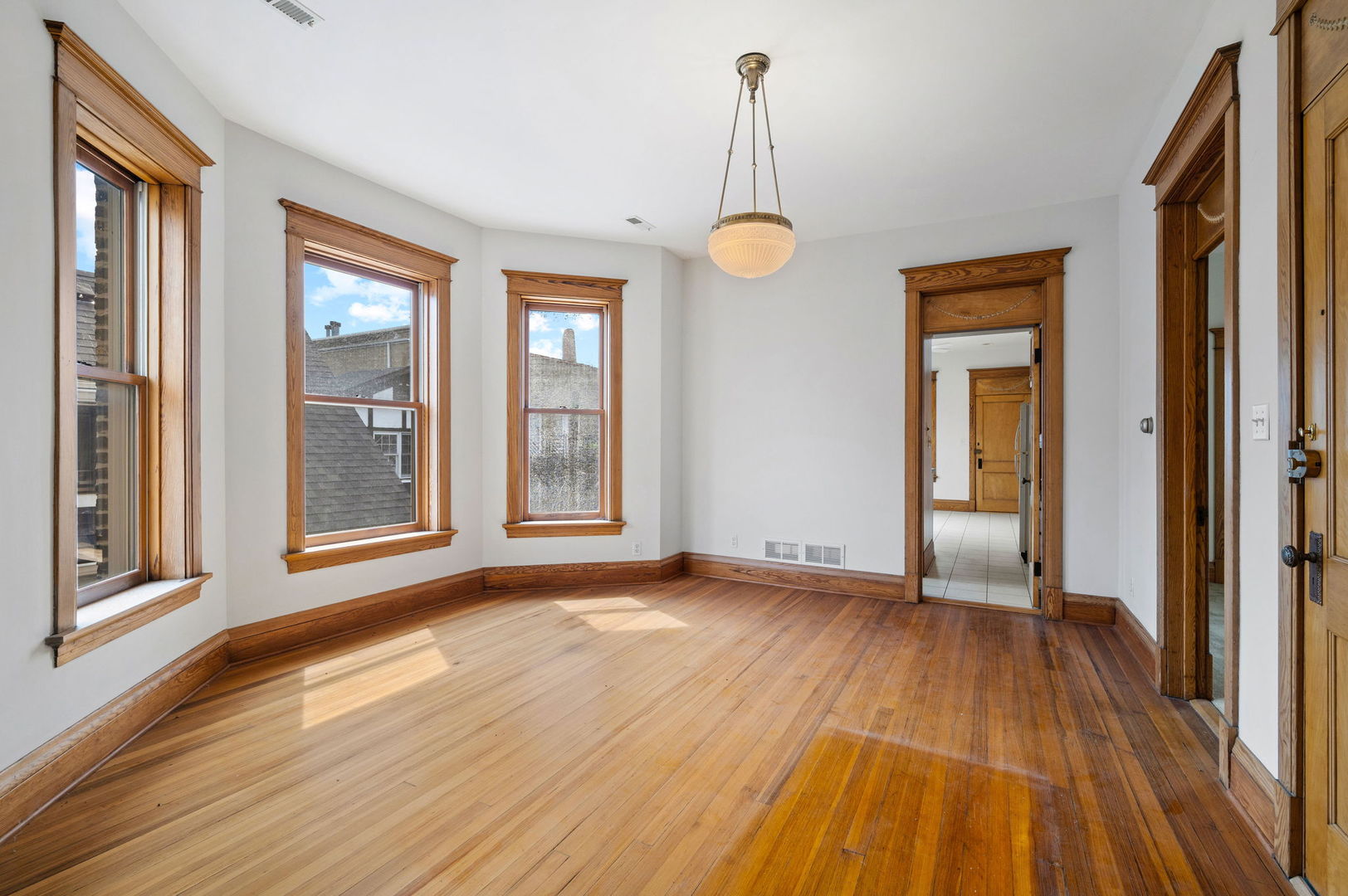 1415 West George Street Chicago, IL 60657 - Photo 24 of 35 a view of empty room with wooden floor and fan