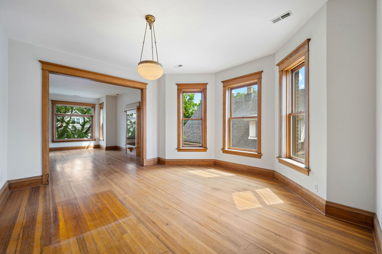1415 West George Street Chicago, IL 60657 - Photo 25 of 35 a view of an empty room with wooden floor and a window