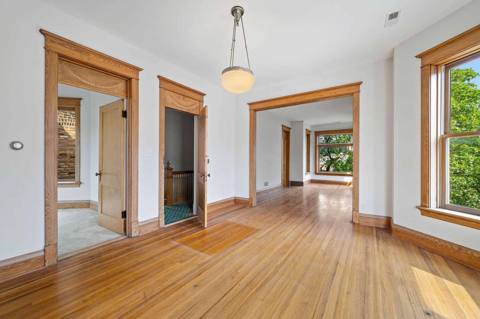 1415 West George Street Chicago, IL 60657 - Photo 26 of 35 a view of a room with wooden floor mirror and windows