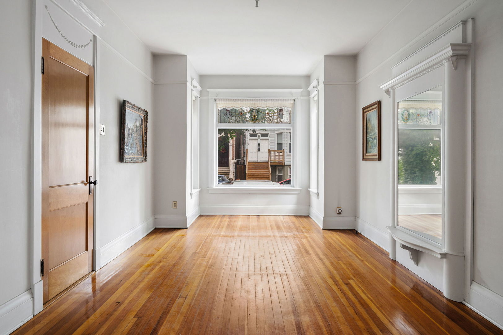 1415 West George Street Chicago, IL 60657 - Photo 4 of 35 a view of an empty room with wooden floor and a window