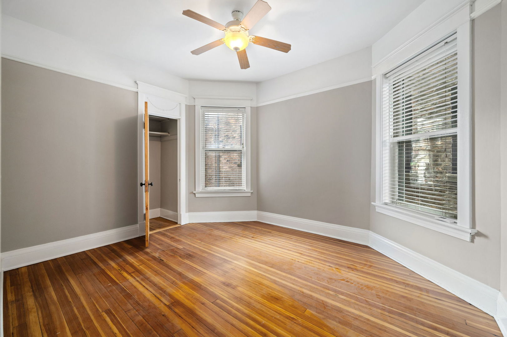 1415 West George Street Chicago, IL 60657 - Photo 10 of 35 a view of empty room with wooden floor and fan