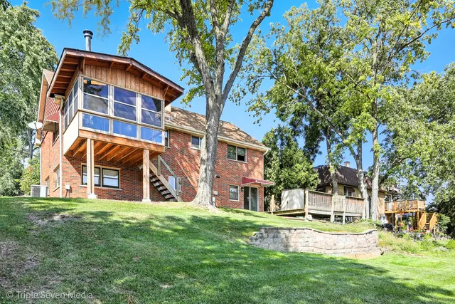 a view of a house with backyard and wooden fence