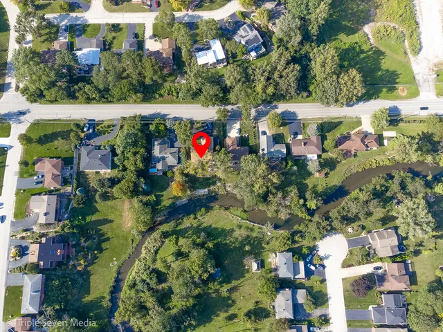an aerial view of a house with a yard and garden