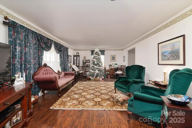 a living room with furniture a rug and a large window