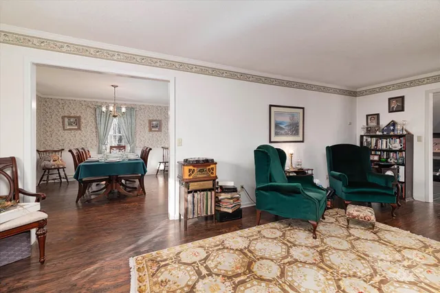 a living room with furniture a table and a potted plant