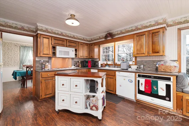 a kitchen with stainless steel appliances granite countertop a stove and cabinets