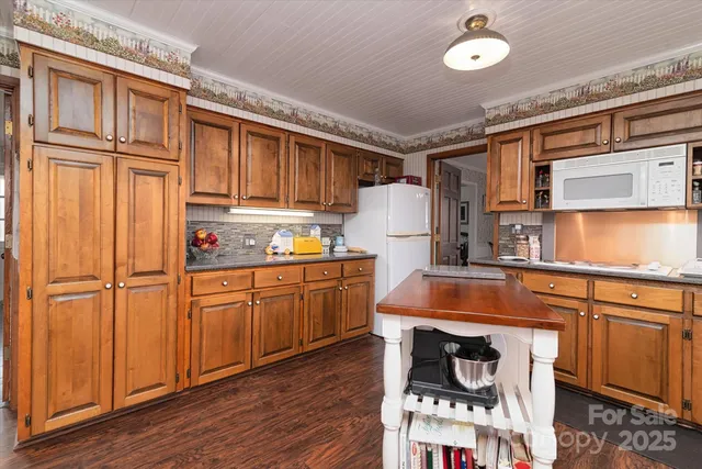 a kitchen with a refrigerator and cabinets