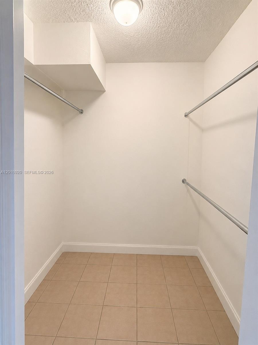 14170 Southwest 84th Street, Unit 404F Miami, FL 33183 - Photo 8 of 18 a view of a room with racks on the wall