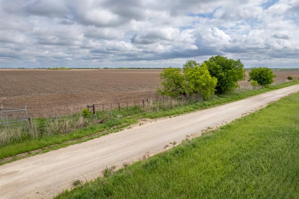 159 County Road 159 Coleman, TX 76834 - Photo 21 of 36 a view of a yard with flower plants and wooden fence