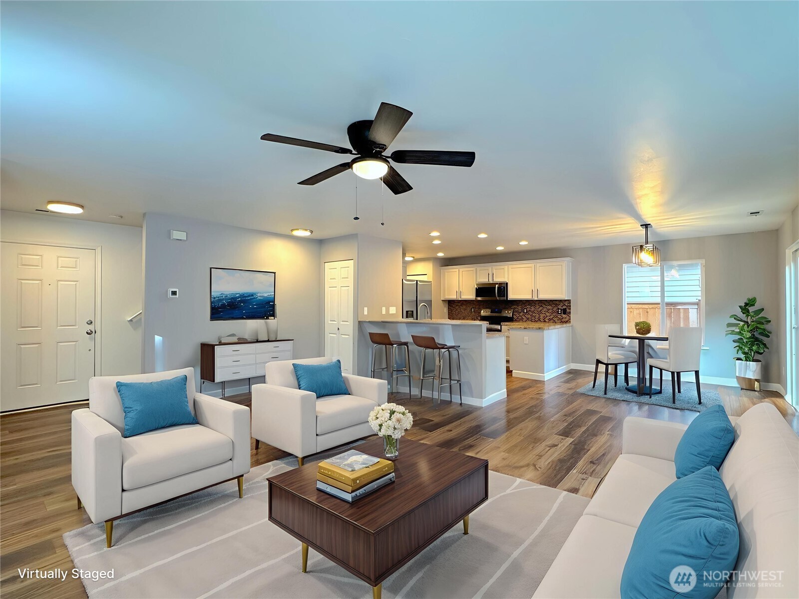 23515 Southeast 243rd Place Maple Valley, WA 98038 - Photo 2 of 28 a living room with furniture kitchen view and a wooden floor