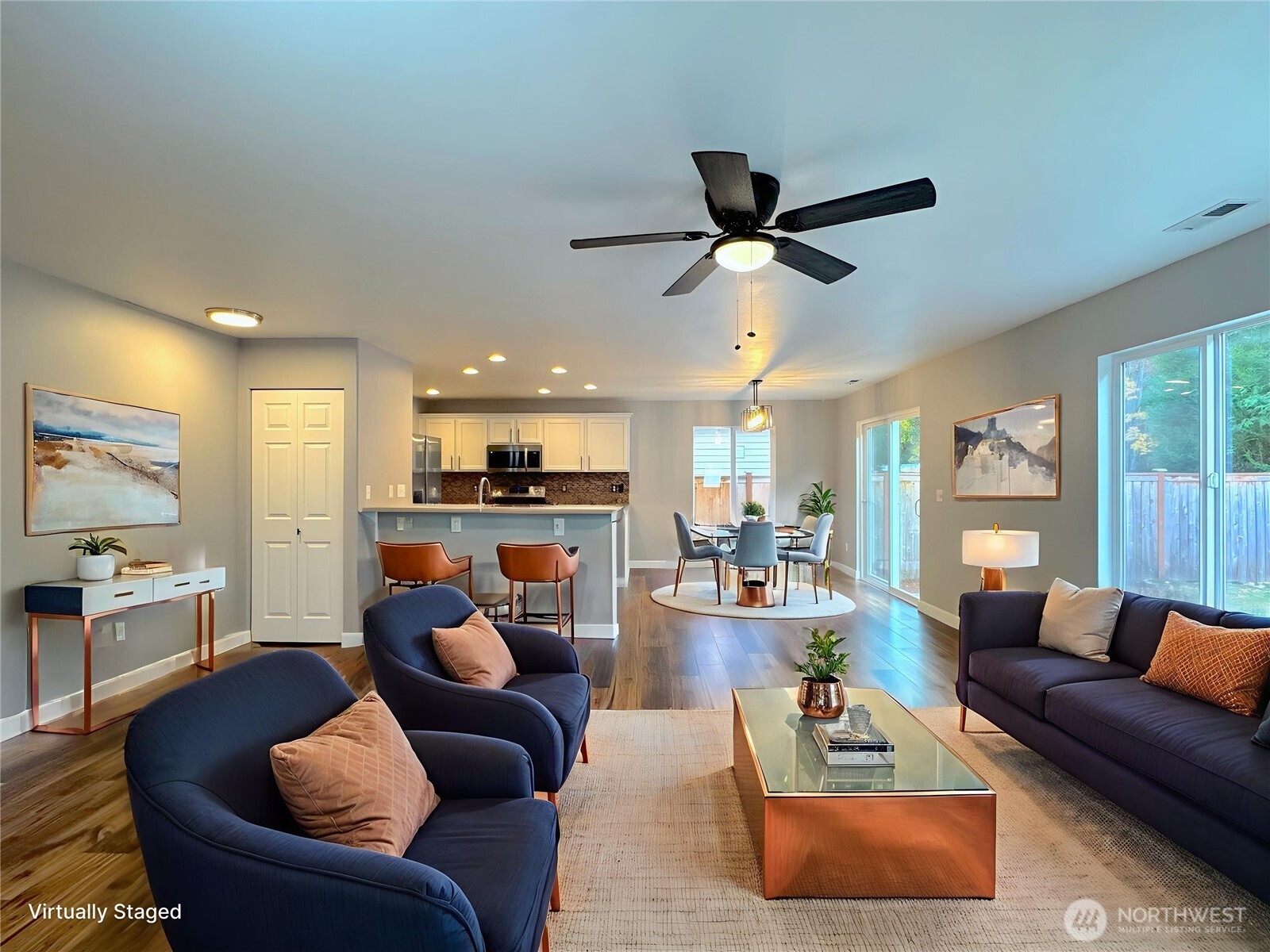 23515 Southeast 243rd Place Maple Valley, WA 98038 - Photo 6 of 28 a living room with furniture a ceiling fan and a large window