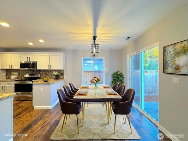 a view of a dining room with furniture window and wooden floor
