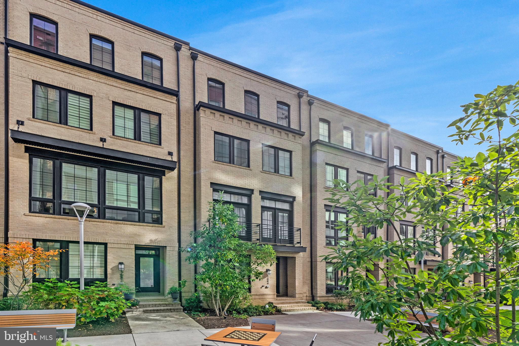 a front view of a building with a garden
