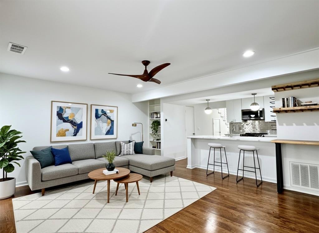4134 Travis Street, Unit 2 Dallas, TX 75204 - Photo 1 of 28 a living room with furniture and a wooden floor