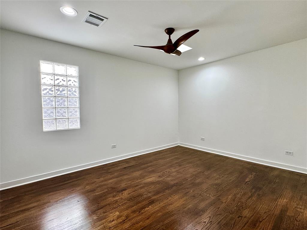 4134 Travis Street, Unit 2 Dallas, TX 75204 - Photo 12 of 28 a view of empty room with wooden floor and fan