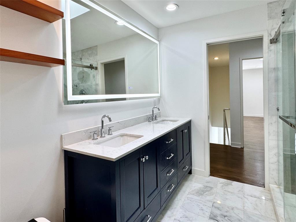 4134 Travis Street, Unit 2 Dallas, TX 75204 - Photo 17 of 28 a bathroom with a sink double vanity and a mirror