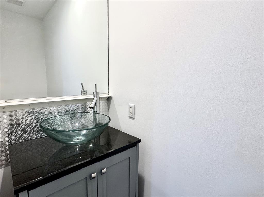 4134 Travis Street, Unit 2 Dallas, TX 75204 - Photo 20 of 28 a close view of a sink and a counter in a bathroom