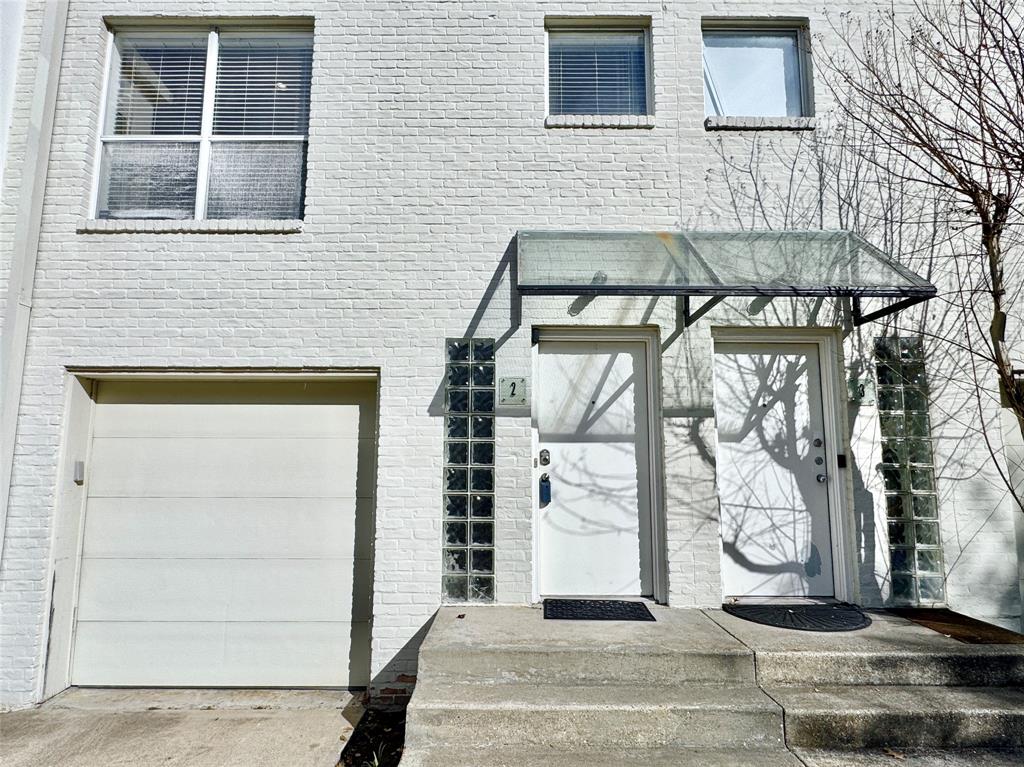 4134 Travis Street, Unit 2 Dallas, TX 75204 - Photo 24 of 28 a front view of a house with a glass door
