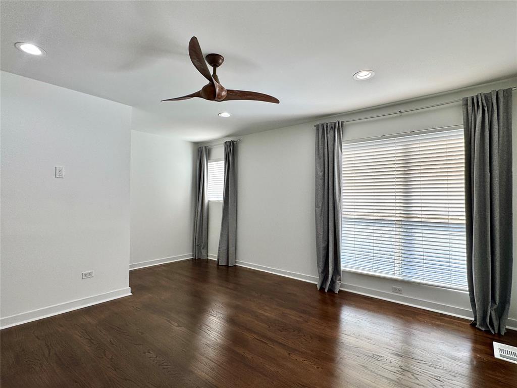 4134 Travis Street, Unit 2 Dallas, TX 75204 - Photo 10 of 28 a view of an empty room with wooden floor and a window