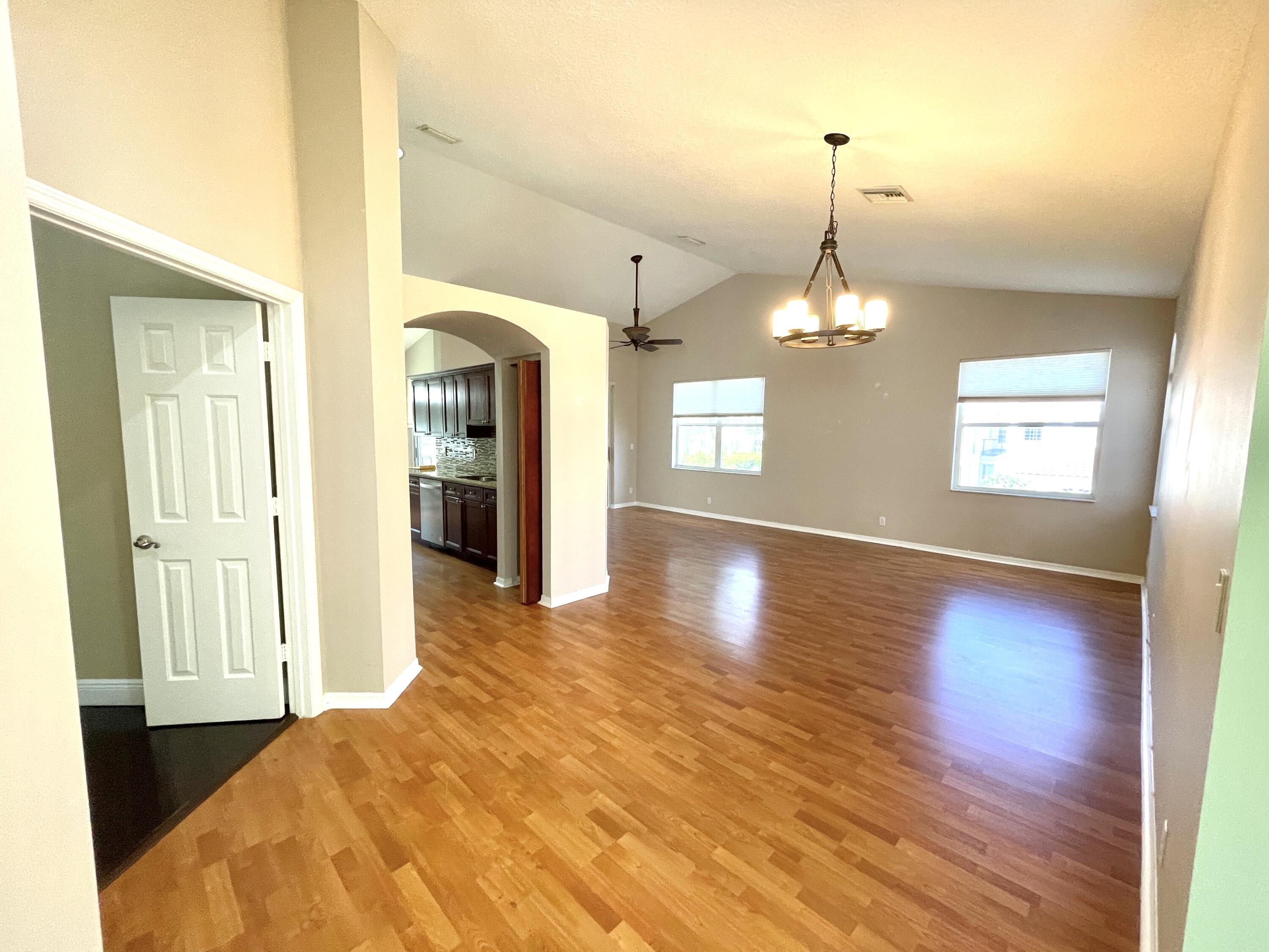 8550 Vía Romana, Unit 2 Boca Raton, FL 33496 - Photo 6 of 28 a view of a bedroom with wooden floor and windows