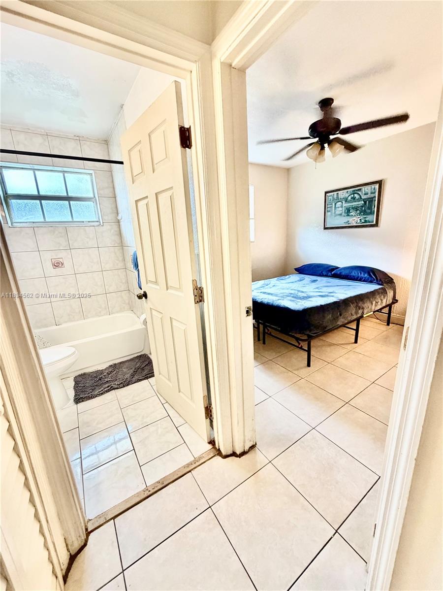 211 Stirling Road, Unit 1 Dania Beach, FL 33004 - Photo 12 of 21 a view of a hallway with wooden floor and a cabinet